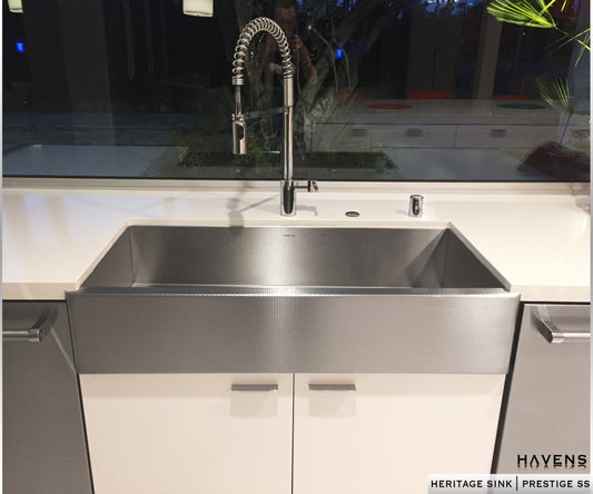 Textured stainless steel farmhouse style kitchen sink. Installed as an undermount, this stainless apron front sink is beautiful.