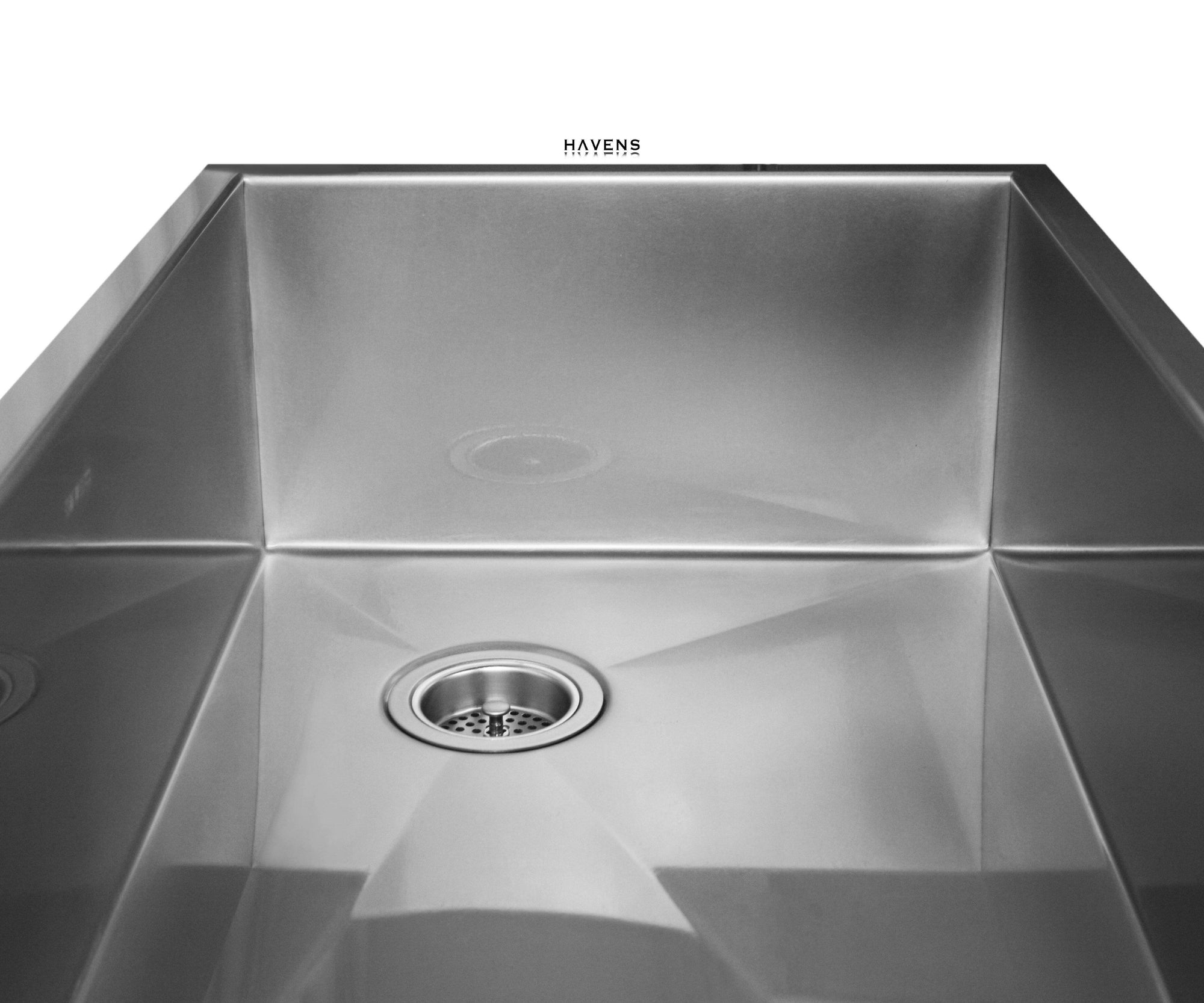 Undermount stainless steel farmhouse sink with a right rear drain.