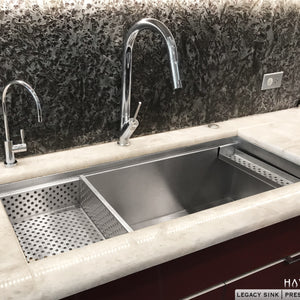 Drop in strainer accessory on left side of sink with advanced luxury sponge caddy on the right side of undermount stainless sink 