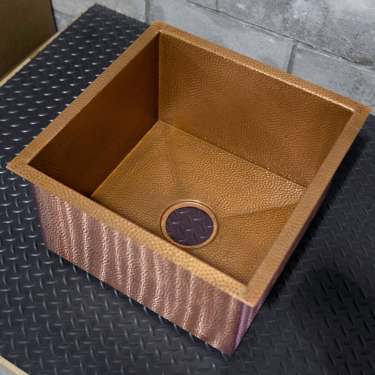 micro-hammered copper heritage sink, angled view of basin and drain