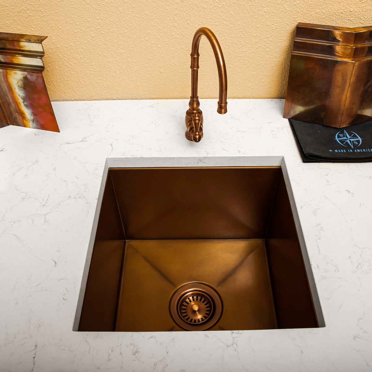 Compact natural copper undermount sink in white countertop with copper faucet