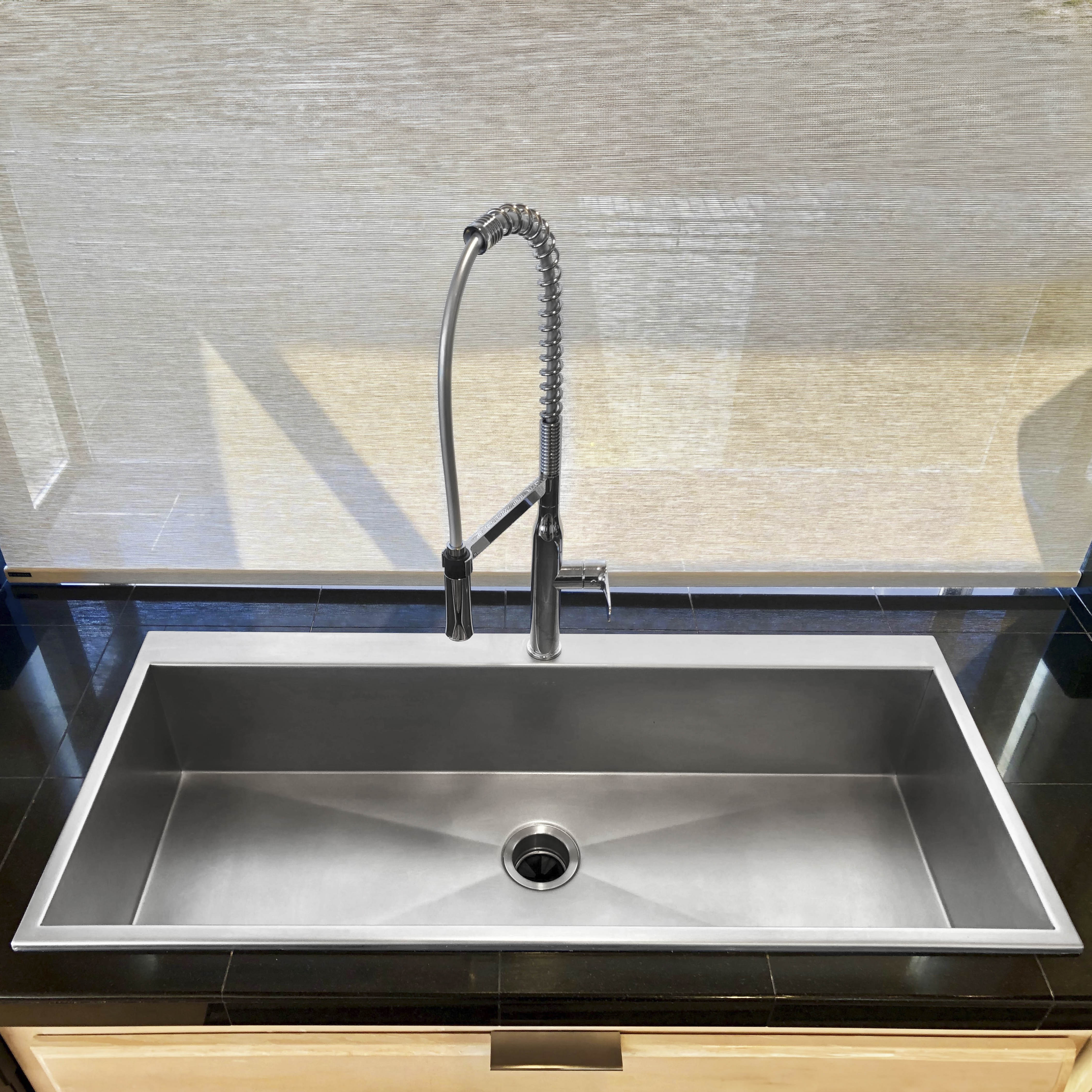 Large single bowl luxe stainless steel kitchen sink with chrome faucet, front view