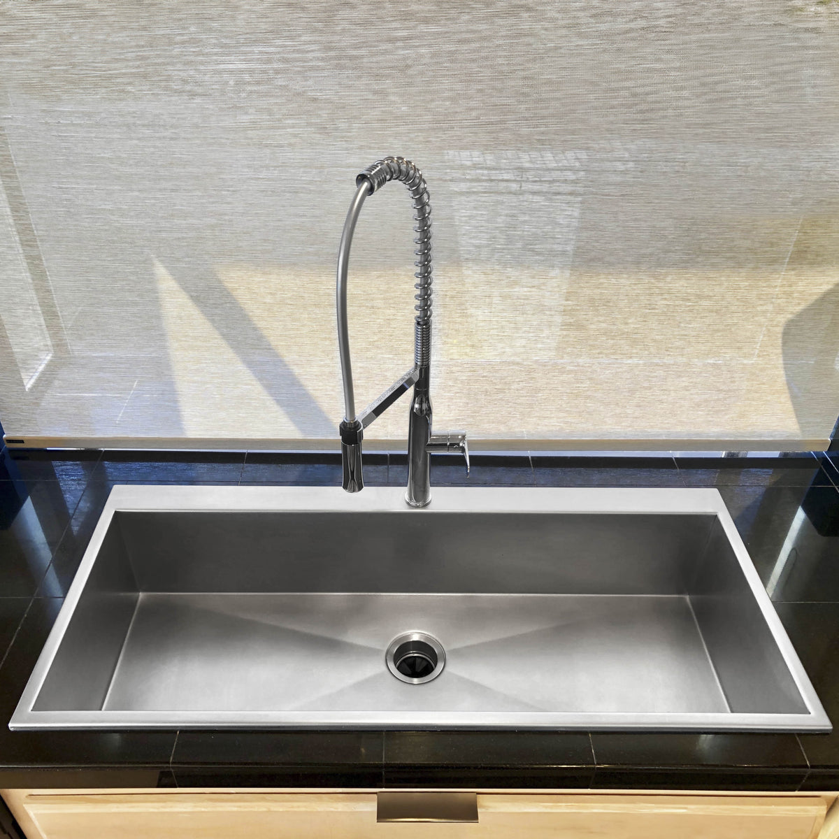 Large single bowl luxe stainless steel kitchen sink with chrome faucet, front view