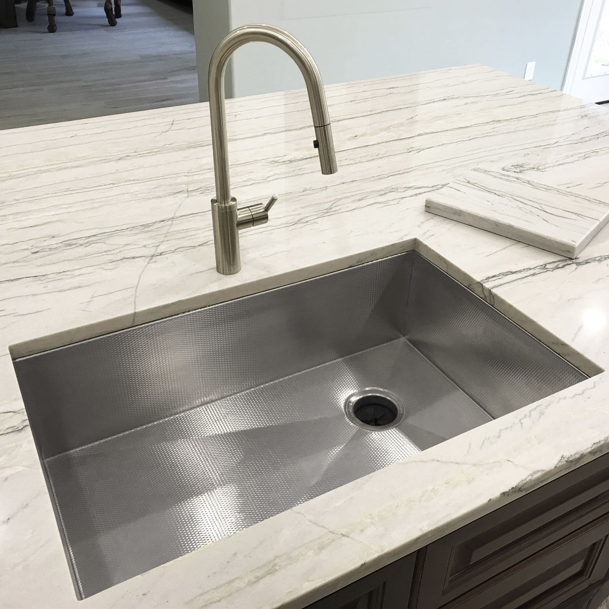 Prestige Stainless steel undermount sink in white marble countertop with brushed faucet