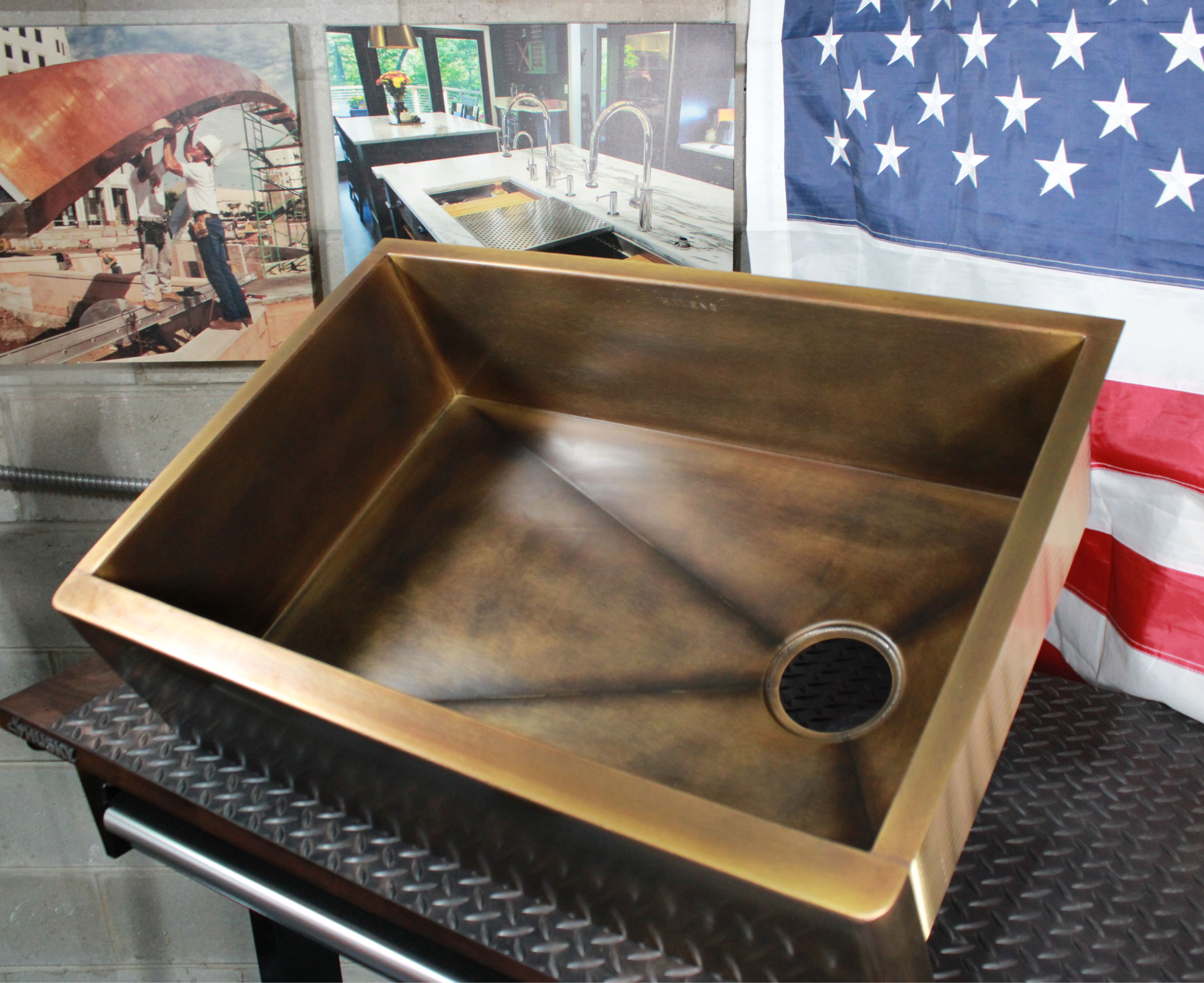 Custom natural aged brass farmhouse sink, top view of basin and right offset drain