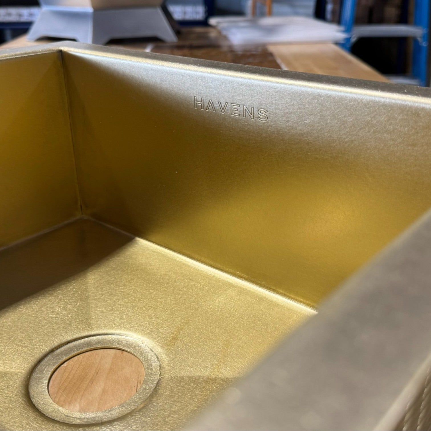 Close-up of luxe brass sink basin corner and drain fitting