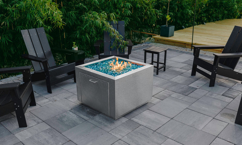Stainless steel fire pits by Havens Luxury Metals with fire glass rocks and propane access door
