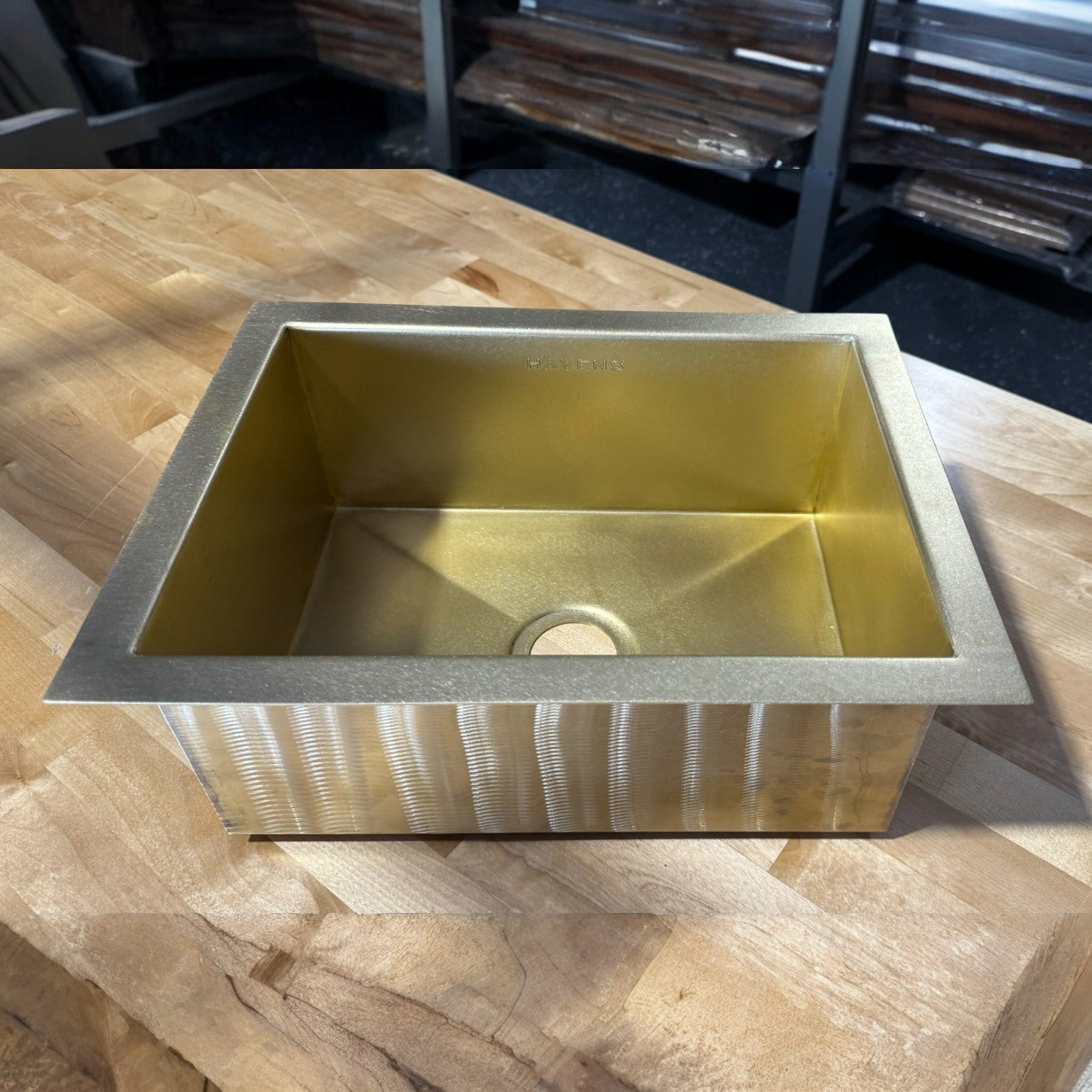 Custom luxe brass small heritage sink on a workbench in a USA metal fabrication shop