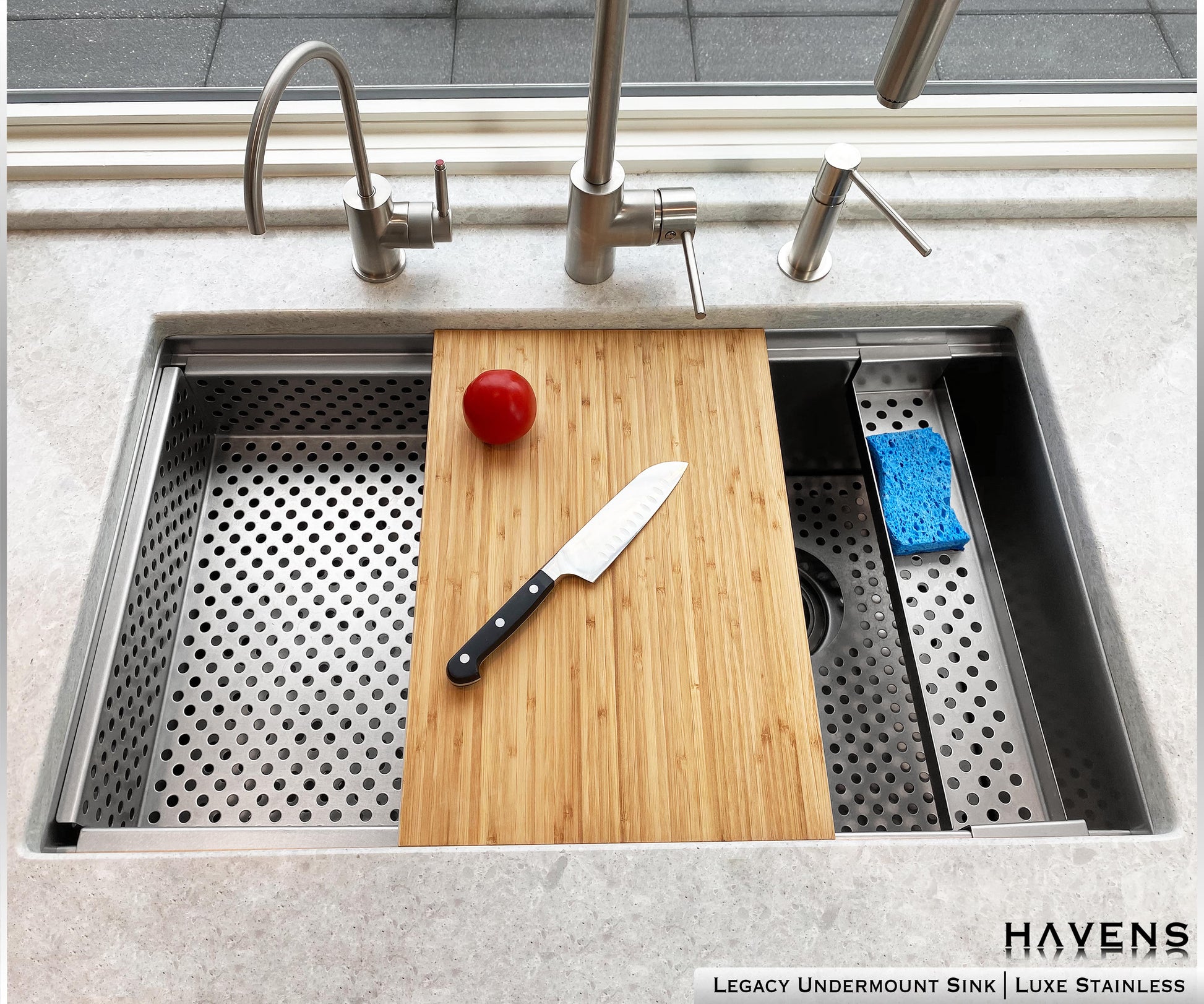 Drop in strainer accessory on left side of undermount sink with Pro cutting board in the middle 