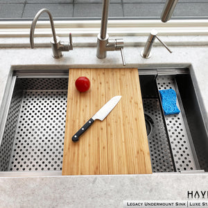 Drop in strainer accessory on left side of undermount sink with Pro cutting board in the middle 
