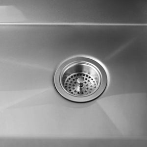 Luxe stainless steel drain placement on an undermount kitchen sink.