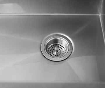 Luxe stainless steel drain placement on an undermount kitchen sink.