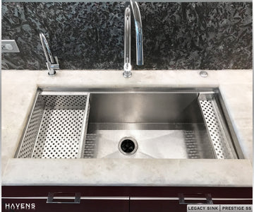 Havens Sponge Caddy with holes resting on advanced workstation ledge of a Stainless Legacy Sink