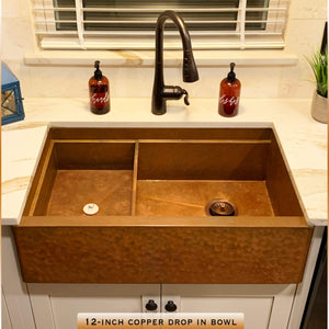 copper drop in bowl placed in farmhouse sink 