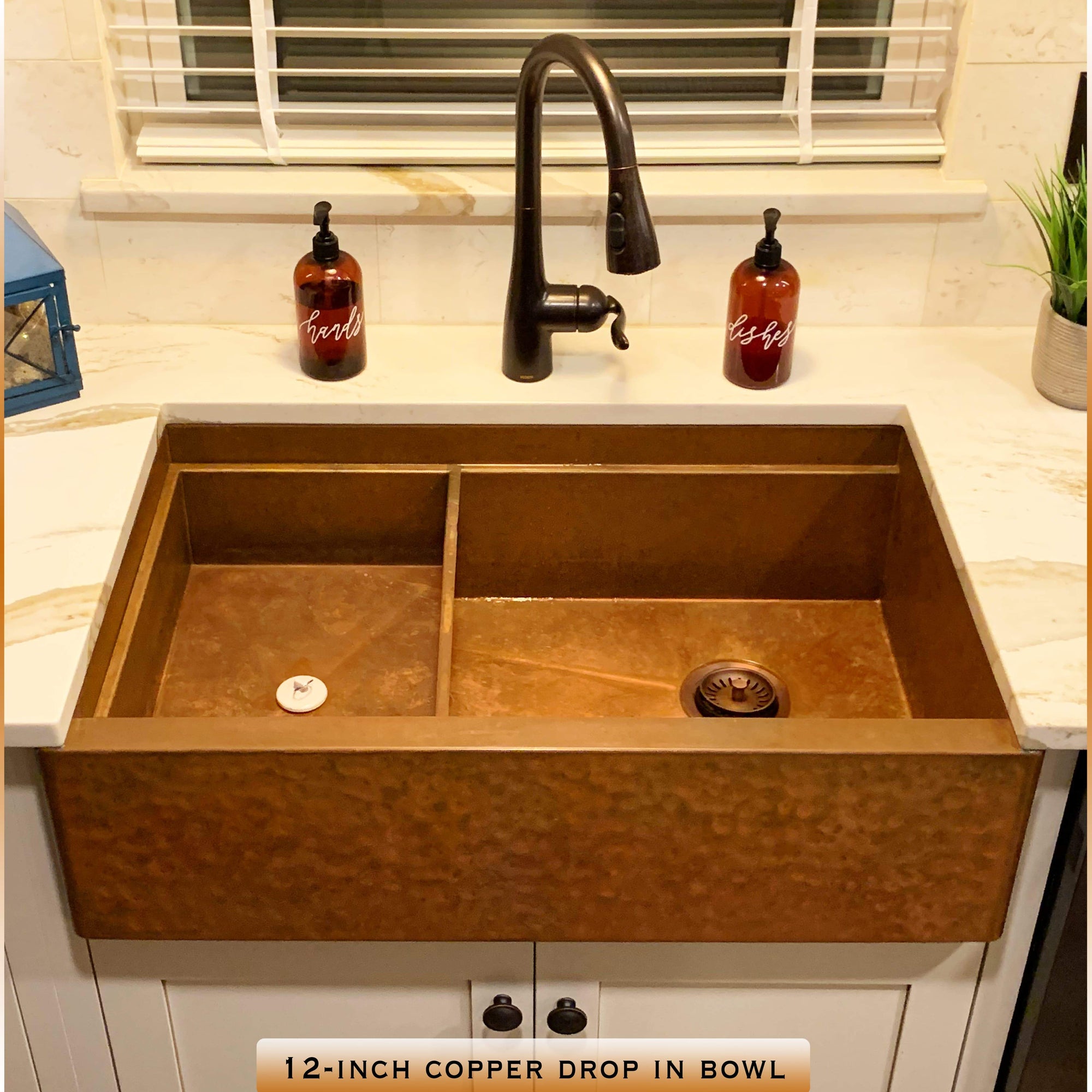 Hammered copper farmhouse sink with antique copper sink installed on right side of sink basin