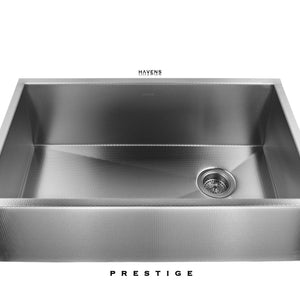 Textured stainless steel farmhouse kitchen sink with a right rear drain.