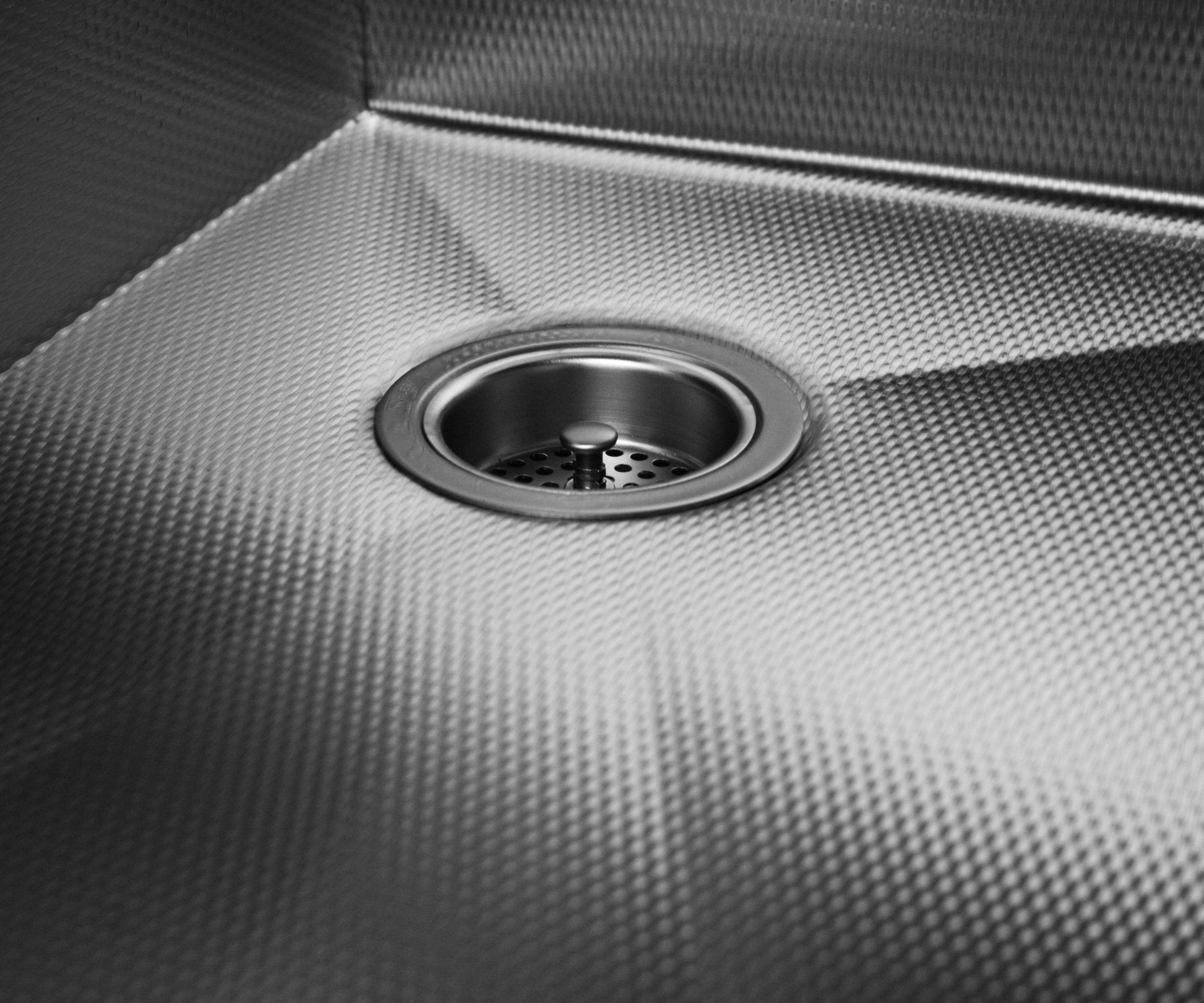 Textured stainless steel kitchen sink with right rear drain placement.