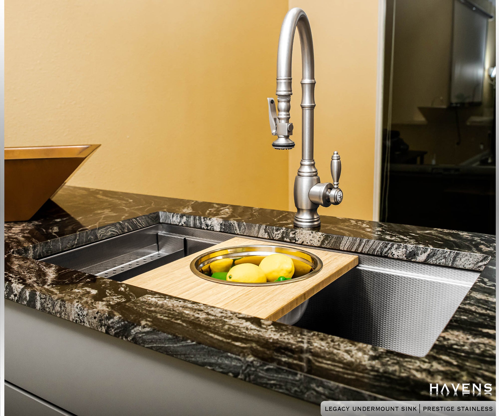 Legacy Undermount Sink with Mixing Bowl Cutting Board holding lemons in stainless steel bowl