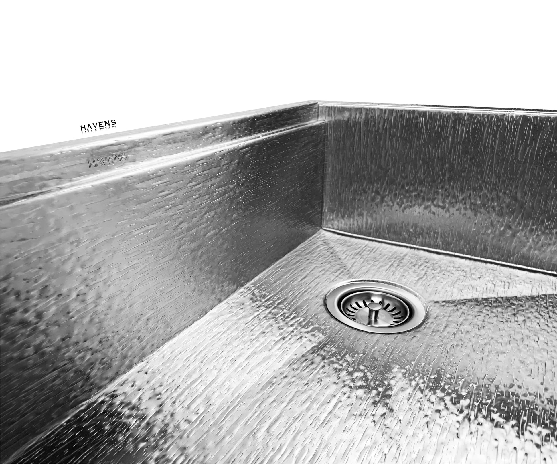 Product image of stainless steel 3.5" kitchen sink drain assembly installed in right rear corner of Havens Metal Sink in Royal Oak finish